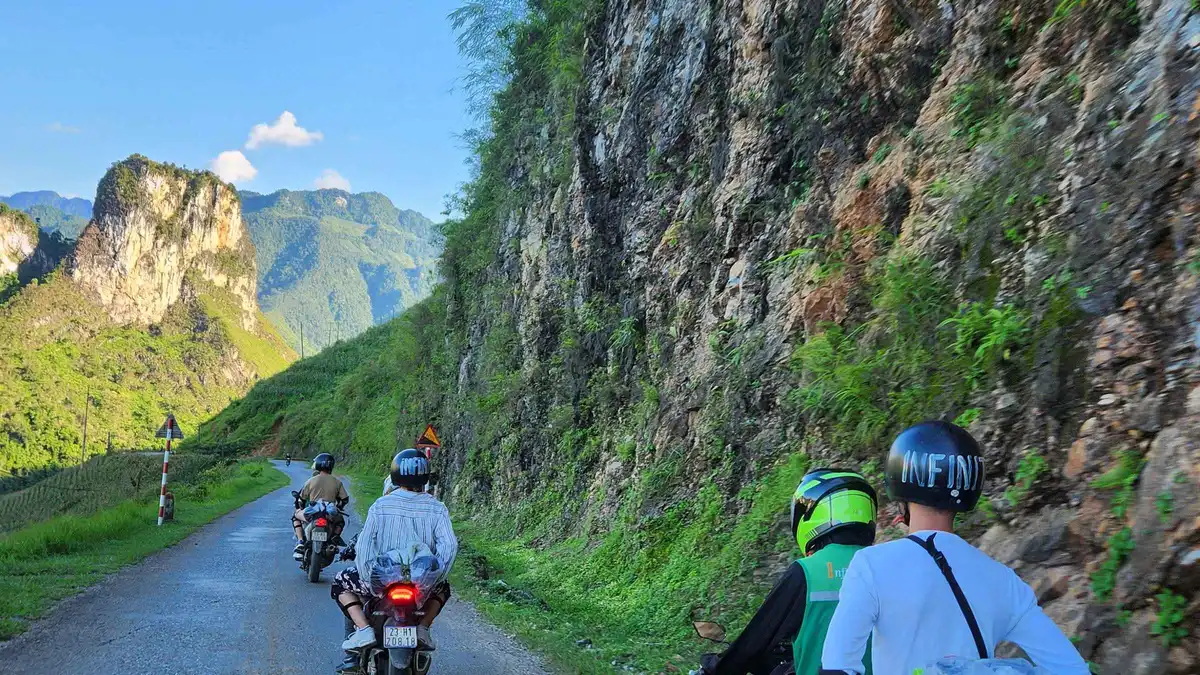Motorbikes parked at a mountain pass viewpoint on a 4-day Ha Giang loop motorcycle tour with an extra night, northern Vietnam