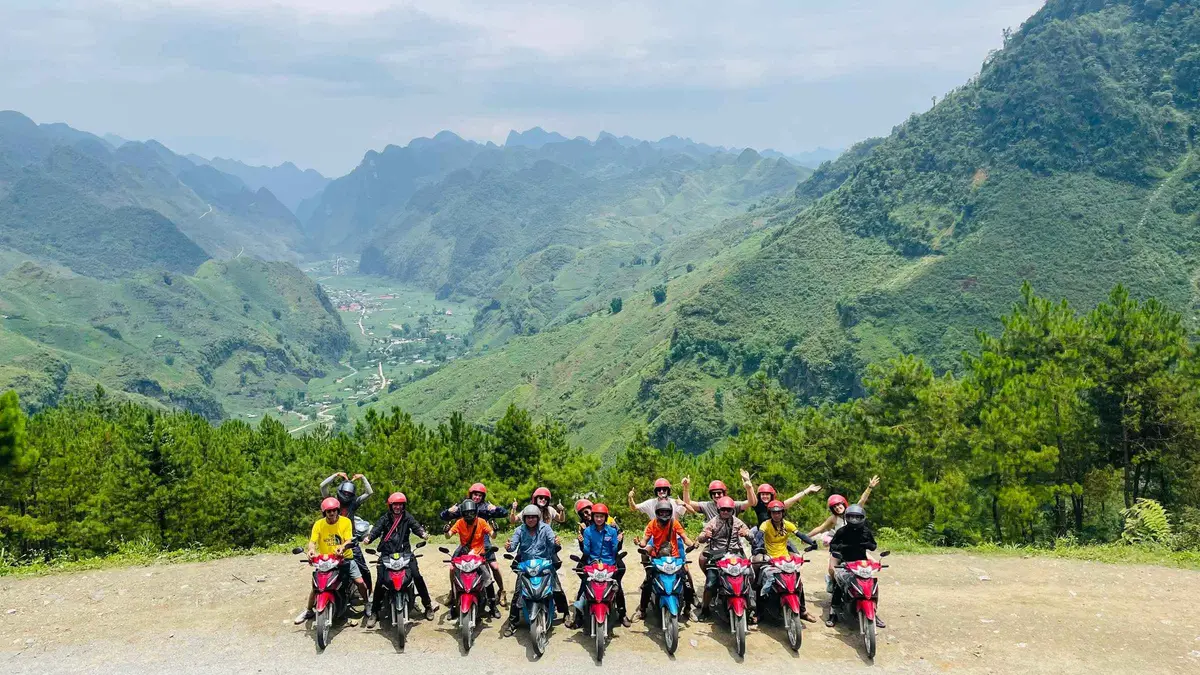 Small capped group riding the Ma Pi Leng cliff road on a 3-day Ha Giang loop motorcycle tour starting from Sapa, Vietnam